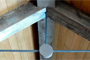 Barnwood wrapped beams with exposed steel support rails